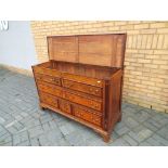 An oak inlaid bedding chest with four drawers and hinged lid, approximately 91 cm x 143 cm x 55 cm.