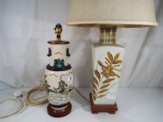 Two ceramic table lamps, one with an Asian theme with Fu dragon detailing.