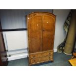 A good quality walnut veneer gentleman's wardrobe over two drawers,