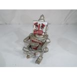 A cast iron novelty money bank in the form of a robot, approximately 17 cm (h).