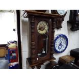A Vienna-styled wall clock in a beech stained case, spring driven movement,