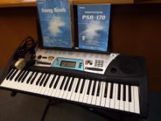 A Yamaha PSR - 170 keyboard with portable stand, owners manual,