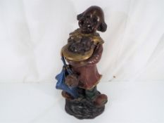 A cold cast painted bronze figure depicting a clown with puppies,