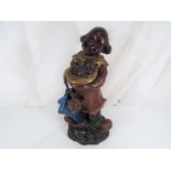 A cold cast painted bronze figure depicting a clown with puppies,