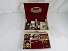 A jewellery casket containing a quantity of lady's costume jewellery.