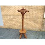 A good quality solid oak hall stand with revolving coat hooks and lower gallery seated area,