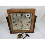 An Art Deco stair-stepped mantel clock, the silvered dial with Arabic numerals, Westminster chimes,