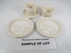 A dinner service on a cream ground with a floral decoration,