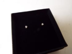 A lady's pair of 9 carat gold 10 point diamond set solitaire stud earrings,