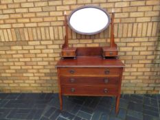 A mahogany dressing table with swivel top mirror and inlaid decoration,