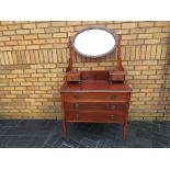 A mahogany dressing table with swivel top mirror and inlaid decoration,