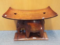 An African hardwood seat carved in the form of an elephant, approximately 51 cm x 59 cm x 19 cm .