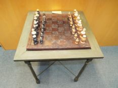 A table in the form of a chess board and card table with inset drawers containing ebony and ivory