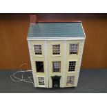 Dolls House - A three storey furnished dolls house of wooden construction, with a mix of wooden,