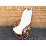 A cane swivel rocking chair - This lot MUST be paid for and collected, or delivery arranged,