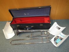 A plated Cavendish trombone, with mouthpiece, carry case, sheet music,
