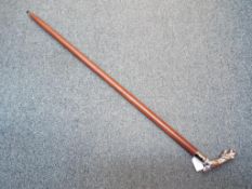 A walking stick with a white metal handl