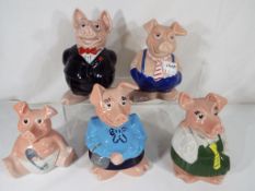 A set of five Wade Westminster bank pigs