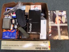 A quantity of cameras and camera equipment, an omelette maker, mobile phones in boxes,
