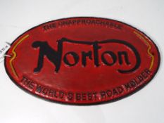 A cast iron sign bearing the name Norto
