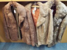 A fur coat and two fur jackets, the coat