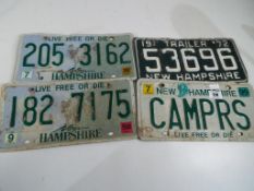 Four vintage American number plates