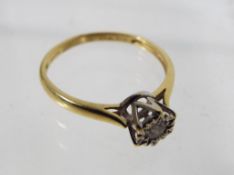 An 18 carat gold diamond solitaire ring.