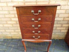 A mahogany music cabinet on cabriole sup