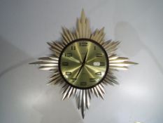 A Metamec sunburst wall clock.