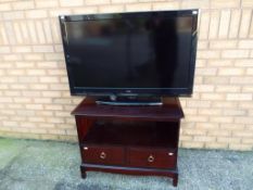 A 39 inch Liasar flatscreen TV (no remote) also included in the lot is a Stag TV unit approx 63cm x