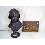 A plaster bust depicting a female and a plaster hand painted wall plaque in the form of Marcus