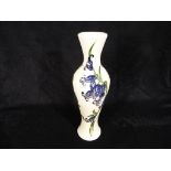 Moorcroft Pottery - a slimline vase decorated with Bluebells,