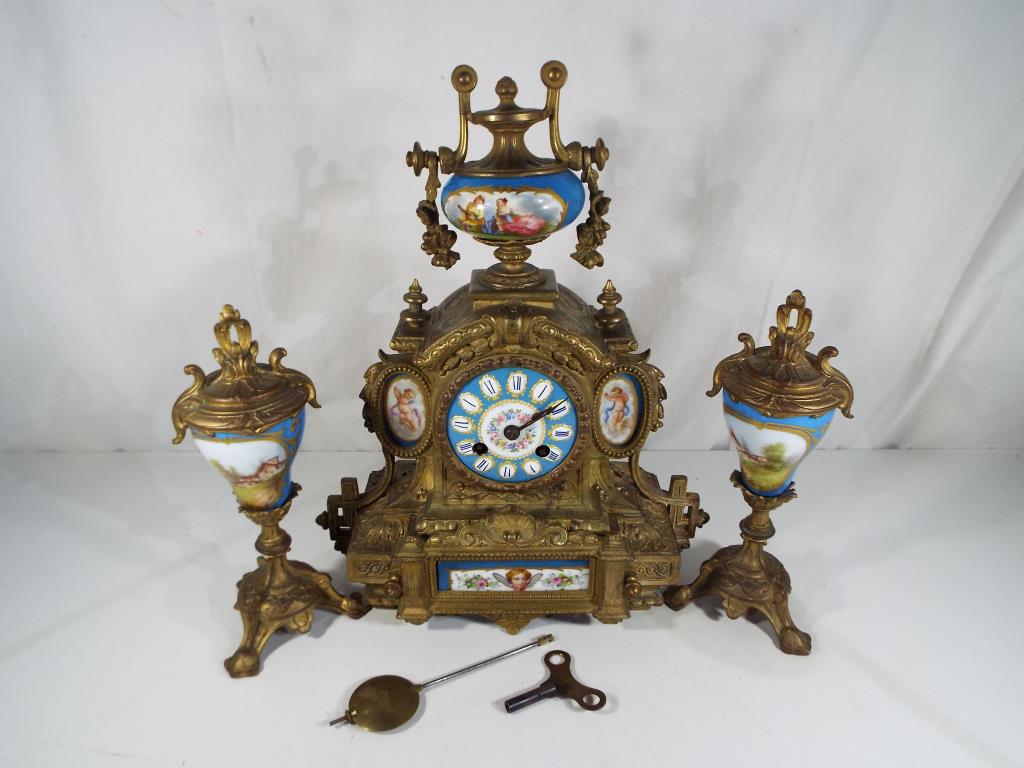 A late 19th century French clock garniture du cheminee,