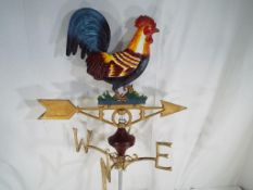 A cast iron weather vane depicting a cockerel,