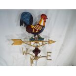 A cast iron weather vane depicting a cockerel,