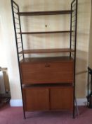 Two mid century teak Ladderax shelving unit systems with bookcases above two lower cupboards,