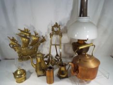 A collection of ornamental copperware and brassware to include an oil lamp, kettle,