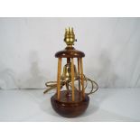 A good quality wood and brass table lamp in the form of a buoy with enamel insert bearing the P & O