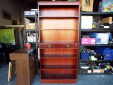 A mahogany open bookshelf having two central drawers approx 194cm x 92cm x 29.