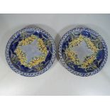 Moorcroft Pottery / MacIntyre - a pair of Moorcroft / MacIntyre Florian Ware plates with a yellow