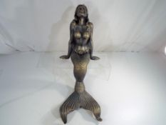 A large cast iron seated statue depicting a mermaid, 50 cm (h).