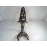 A large cast iron seated statue depicting a mermaid, 50 cm (h).