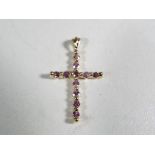A 9 carat gold and pink sapphire cross - This lot MUST be paid for and collected,