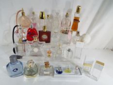 In excess of 25 perfume bottles some with contents to include Ariana Grande, Adidas, Coco Chanel,