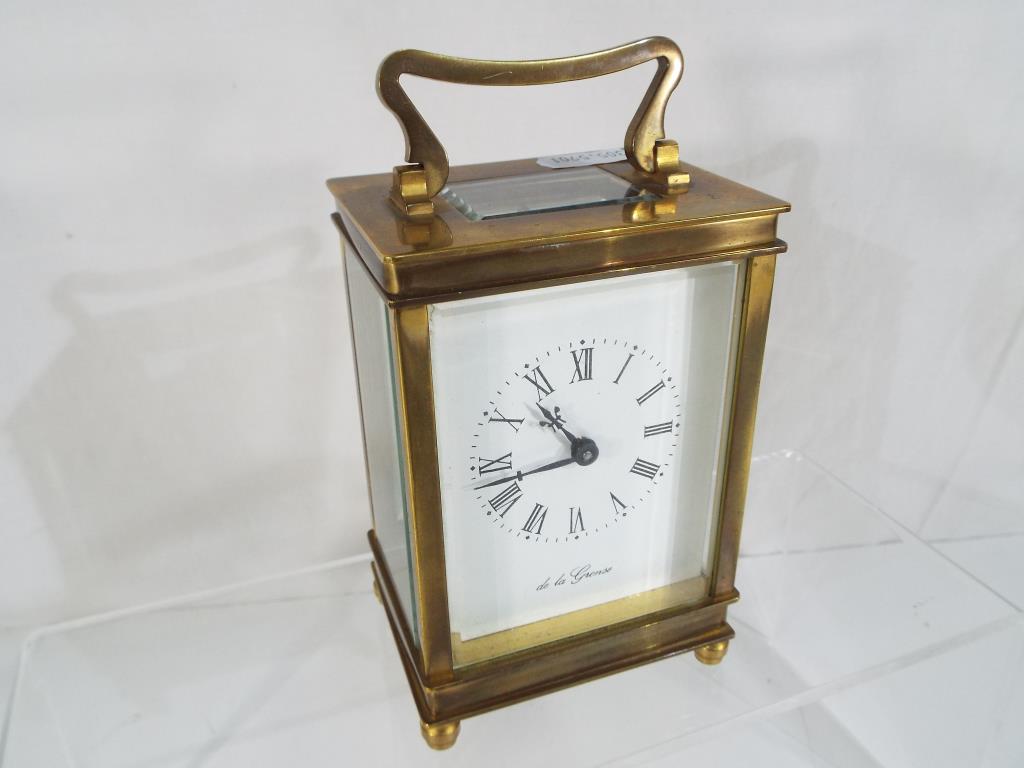 A brass cased carriage clock, the dial scribed 'De la Grense' Roman numerals,