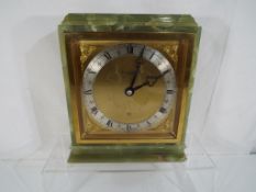 A green marble mantel clock by Elliott retailed by Boodle and Dunthorne,