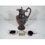 A plated ewer, approximately 23 cm (h), a plated salt with blue glass liner,