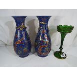 A pair of Chinese vases decorated with flowers and dragons on a blue ground,