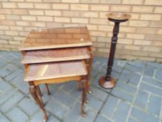A nest of three occasional table with glass tops also included in the lot is a wooden smokers