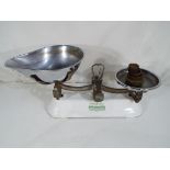 A set of kitchen scales by Berry and Warmington with enamelled base and weights.